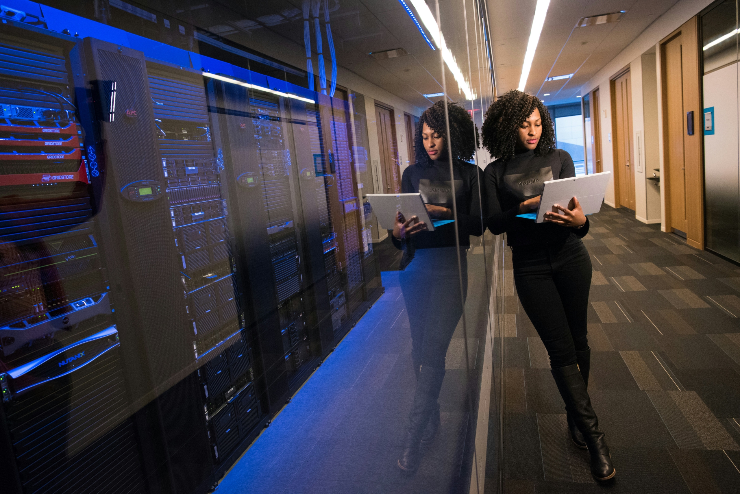 Businesswoman standing confidently in front of a server room, symbolising Africa’s evolving tech and data landscape.